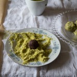 Rolling chocolate truffles in pistachios