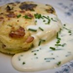 spring green and bacon potato cake with cheddar and chive sauce