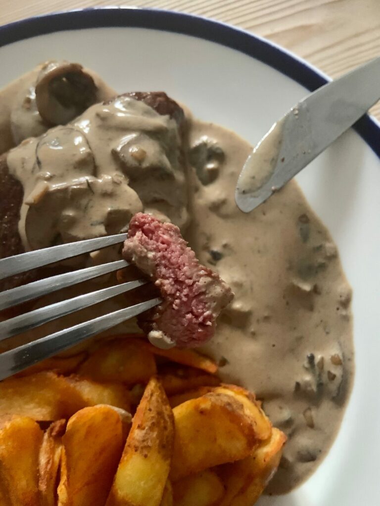 Cooked steak with mushroom sauce